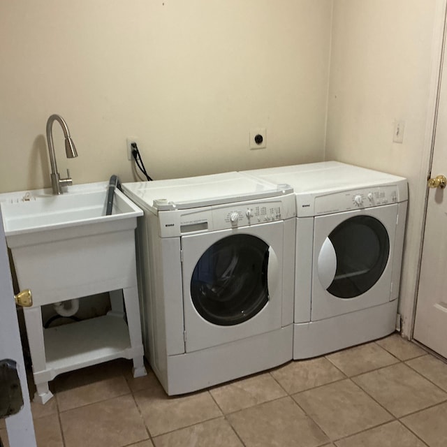 26766 Plumgrove Ln Unit 56, Farmington Hills, MI 48334 - clothes washing area featuring separate washer and dryer, light tile patterned floors, and laundry area