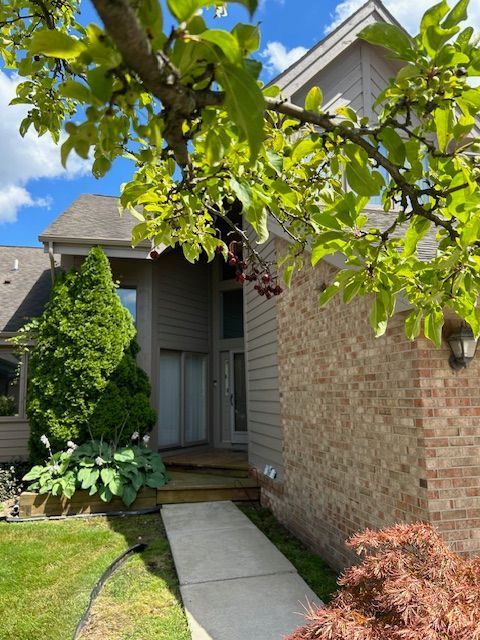 26766 Plumgrove Ln Unit 56, Farmington Hills, MI 48334 - property entrance featuring brick siding