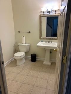 26766 Plumgrove Ln Unit 56, Farmington Hills, MI 48334 - bathroom with baseboards, toilet, and tile patterned flooring