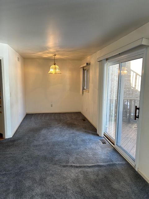 26766 Plumgrove Ln Unit 56, Farmington Hills, MI 48334 - carpeted empty room featuring visible vents
