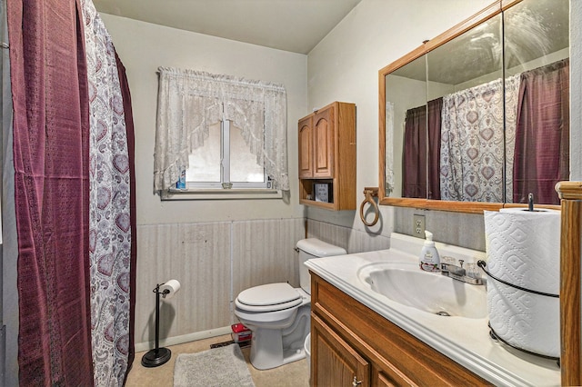 9448 Washburn Rd, Columbiaville, MI 48421 - full bathroom featuring vanity, toilet, curtained shower, and a wainscoted wall