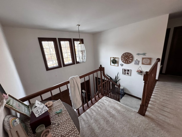 stairs featuring carpet flooring and baseboards