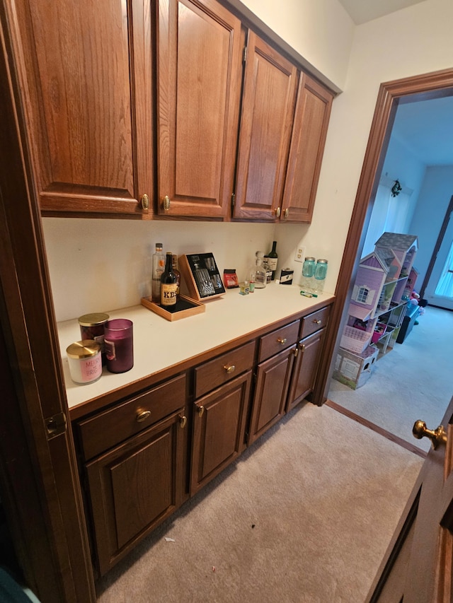 kitchen featuring light carpet and light countertops