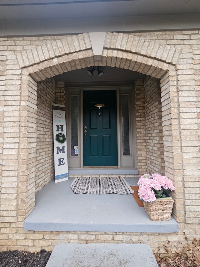 property entrance with brick siding