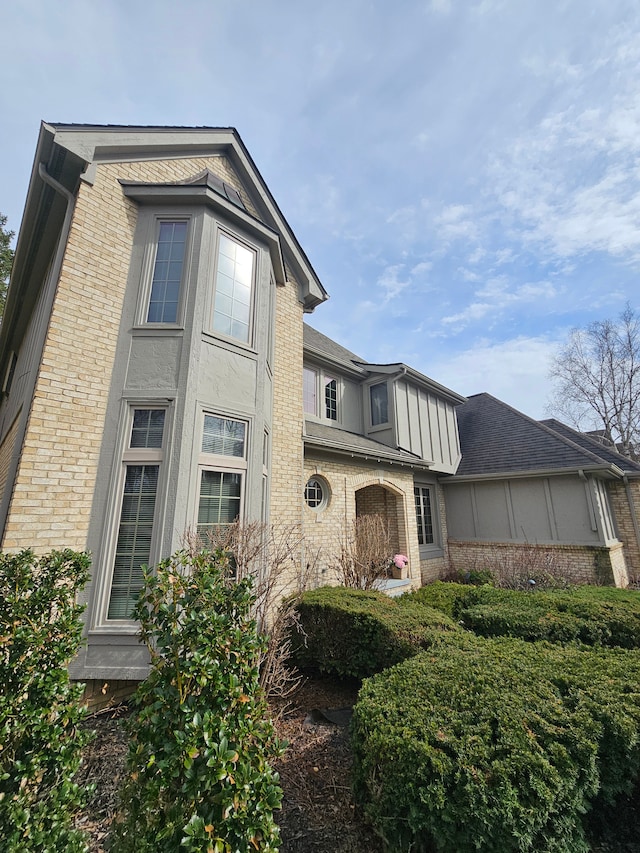 view of side of property featuring brick siding
