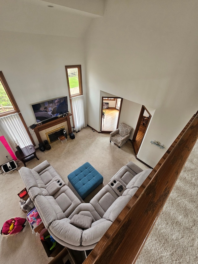 living area featuring carpet flooring and a towering ceiling