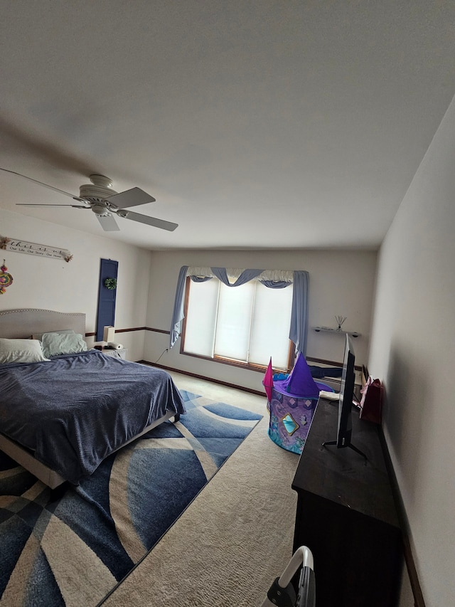 bedroom featuring ceiling fan, baseboards, and carpet floors