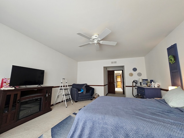carpeted bedroom with ceiling fan and visible vents
