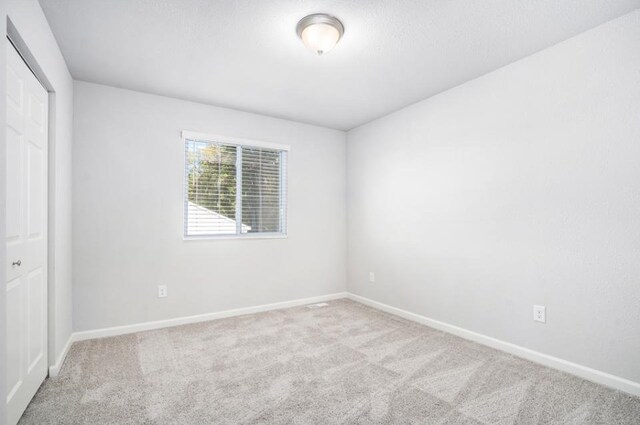 550 Needlewood Dr, Cedar Springs, MI 49319 - unfurnished bedroom with carpet, baseboards, and a closet