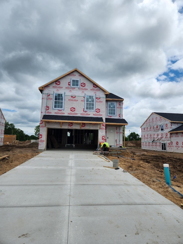 550 Needlewood Dr, Cedar Springs, MI 49319 - unfinished property featuring a garage and concrete driveway