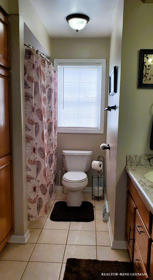 5393 Blaine Ave SE, Grand Rapids, MI 49508 - full bath featuring baseboards, toilet, a shower with shower curtain, tile patterned floors, and vanity