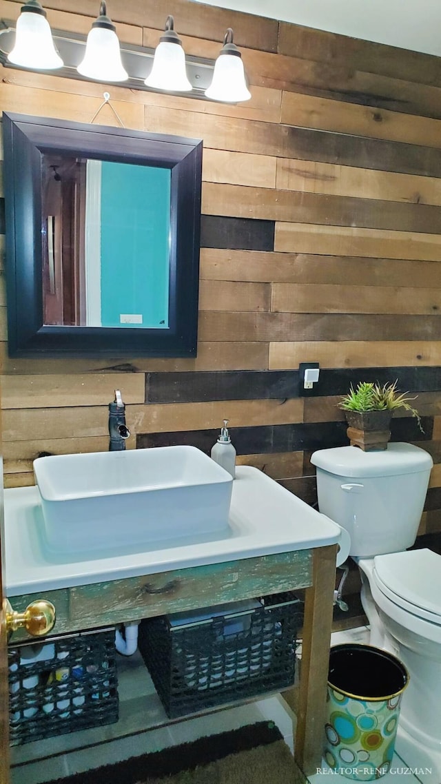 5393 Blaine Ave SE, Grand Rapids, MI 49508 - bathroom with wooden walls, vanity, and toilet