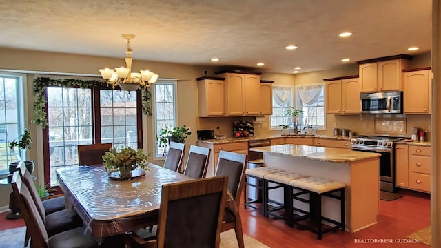 5393 Blaine Ave SE, Grand Rapids, MI 49508 - dining space with recessed lighting, dark wood-type flooring, and a chandelier