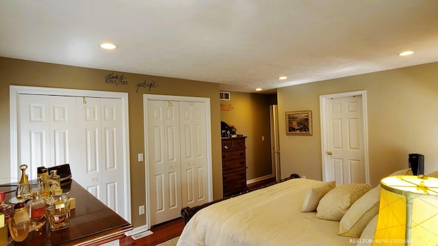 5393 Blaine Ave SE, Grand Rapids, MI 49508 - bedroom featuring visible vents, recessed lighting, two closets, and dark wood-type flooring