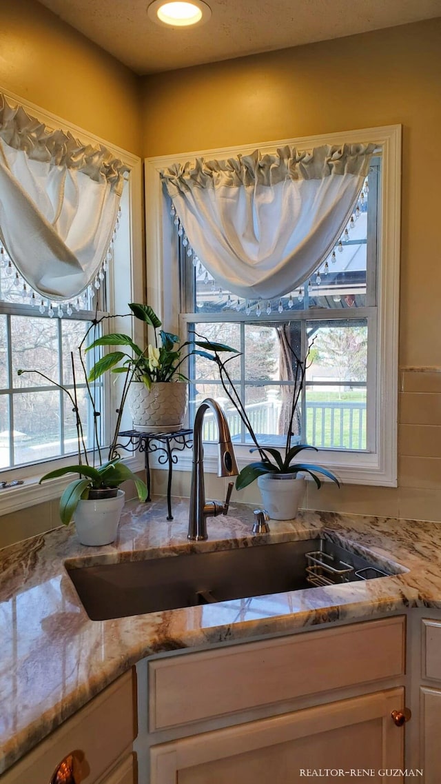 5393 Blaine Ave SE, Grand Rapids, MI 49508 - room details with a sink and light stone countertops