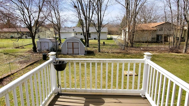 5393 Blaine Ave SE, Grand Rapids, MI 49508 - deck featuring a residential view, a lawn, an outdoor structure, and a shed