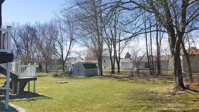5393 Blaine Ave SE, Grand Rapids, MI 49508 - view of yard with a storage unit, an outdoor structure, stairs, and fence