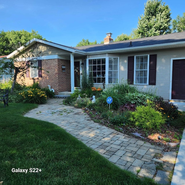 5393 Blaine Ave SE, Grand Rapids, MI 49508 - ranch-style house featuring a front yard and a chimney