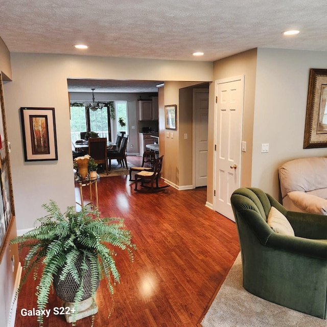 5393 Blaine Ave SE, Grand Rapids, MI 49508 - living room with baseboards, dark wood finished floors, recessed lighting, a notable chandelier, and a textured ceiling