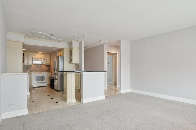 555 E William St, Ann Arbor, MI 48104 - kitchen featuring white appliances, light colored carpet, tasteful backsplash, cream cabinets, and baseboards