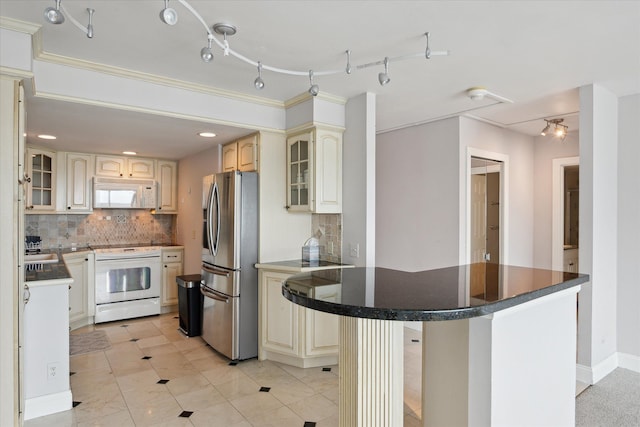555 E William St, Ann Arbor, MI 48104 - kitchen with white appliances, cream cabinets, decorative backsplash, glass insert cabinets, and recessed lighting