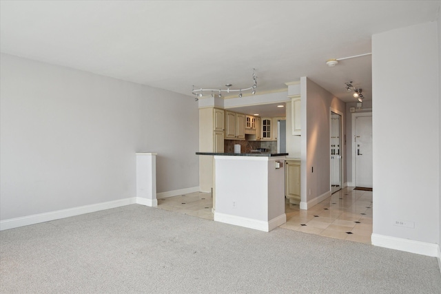 555 E William St, Ann Arbor, MI 48104 - unfurnished living room featuring light colored carpet, baseboards, and light tile patterned floors