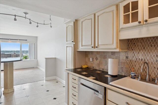 555 E William St, Ann Arbor, MI 48104 - kitchen featuring cream cabinetry, dishwasher, a sink, and baseboards