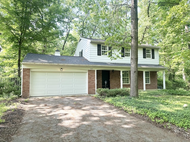 7325 Sheffield Dr SE, Ada, MI 49301 - traditional-style home featuring driveway, brick siding, an attached garage, and a chimney