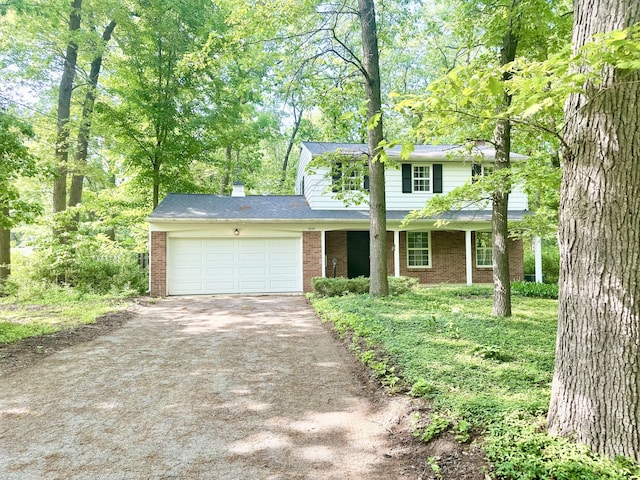 7325 Sheffield Dr SE, Ada, MI 49301 - traditional home with asphalt driveway, brick siding, and an attached garage