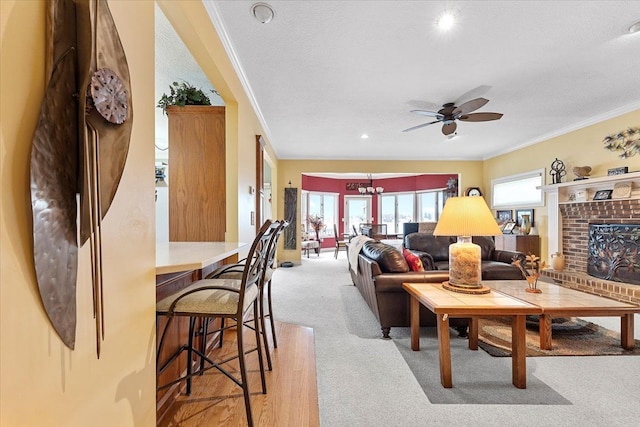 9283 Firwood Rd, South Lyon, MI 48178 - living room with carpet flooring, a ceiling fan, a fireplace, a textured ceiling, and ornamental molding