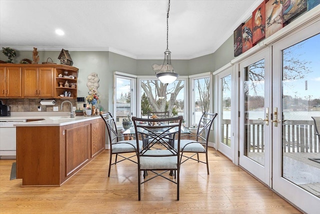 9283 Firwood Rd, South Lyon, MI 48178 - dining area featuring crown molding and light wood finished floors