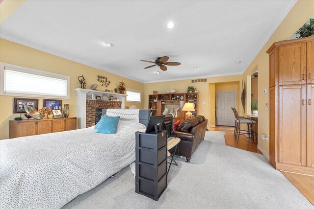 9283 Firwood Rd, South Lyon, MI 48178 - bedroom with crown molding, baseboards, visible vents, a ceiling fan, and a fireplace