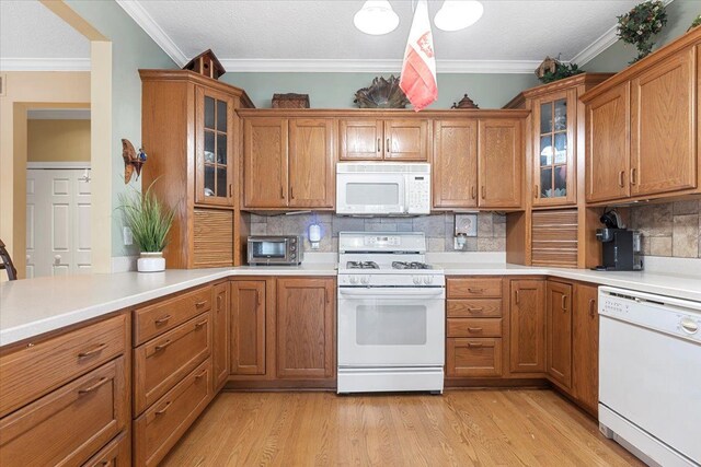 9283 Firwood Rd, South Lyon, MI 48178 - kitchen featuring crown molding, brown cabinetry, light wood finished floors, and white appliances