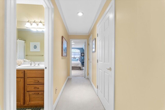 9283 Firwood Rd, South Lyon, MI 48178 - hall with a sink, crown molding, baseboards, and light colored carpet