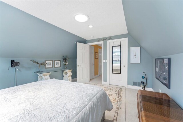 9283 Firwood Rd, South Lyon, MI 48178 - bedroom featuring baseboards, lofted ceiling, visible vents, and carpet floors