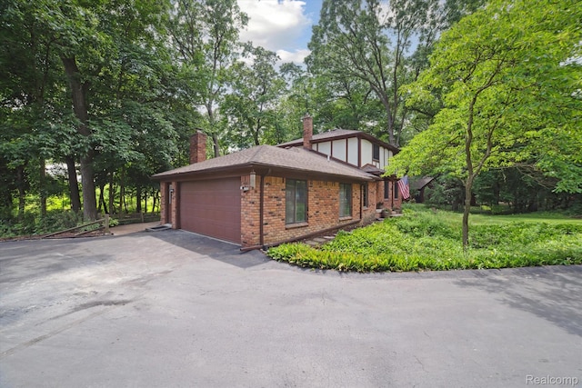 2915 Hillendale Dr, Rochester Hills, MI 48309 - view of property exterior featuring brick siding, a chimney, a garage, and roof with shingles
