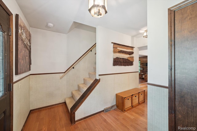 2915 Hillendale Dr, Rochester Hills, MI 48309 - stairs featuring wainscoting, wood-type flooring, and a chandelier