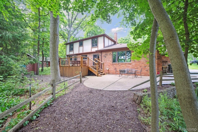 2915 Hillendale Dr, Rochester Hills, MI 48309 - rear view of property with a deck, a patio, brick siding, a chimney, and stairway