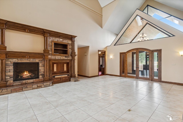 8650 Stone Rd, Maybee, MI 48159 - unfurnished living room with a fireplace, a towering ceiling, light tile patterned floors, plenty of natural light, and french doors