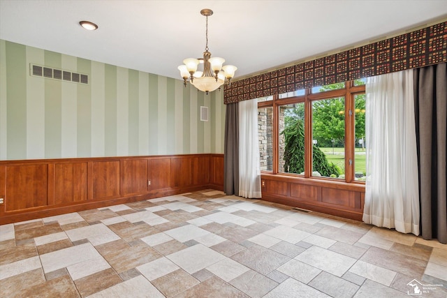 8650 Stone Rd, Maybee, MI 48159 - spare room with a chandelier and wainscoting