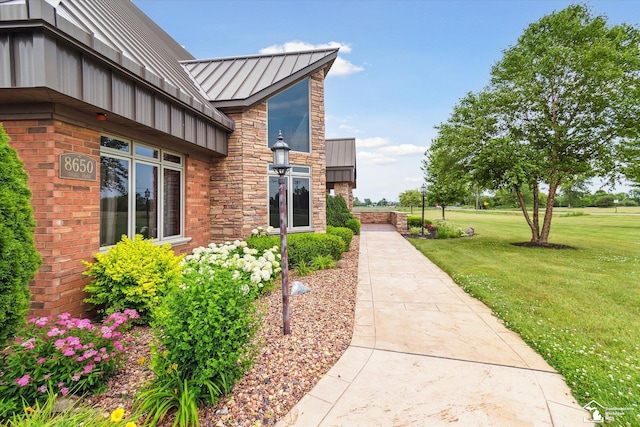 8650 Stone Rd, Maybee, MI 48159 - view of property exterior featuring a standing seam roof, a lawn, a metal roof, and board and batten siding