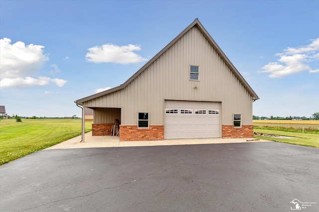 8650 Stone Rd, Maybee, MI 48159 - view of home's exterior with board and batten siding, brick siding, a garage, and an outdoor structure
