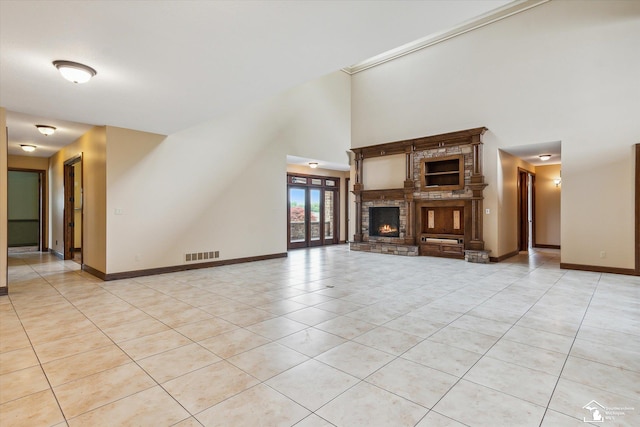 8650 Stone Rd, Maybee, MI 48159 - unfurnished living room featuring light tile patterned floors, a high ceiling, and a fireplace