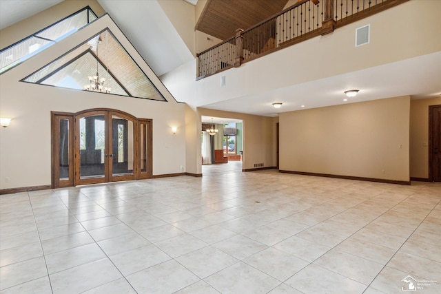 8650 Stone Rd, Maybee, MI 48159 - unfurnished living room with a chandelier, french doors, a high ceiling, and light tile patterned floors