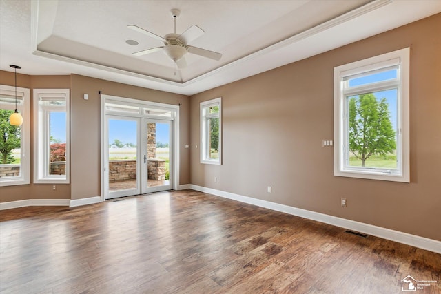 8650 Stone Rd, Maybee, MI 48159 - empty room with a tray ceiling, wood finished floors, ceiling fan, and french doors