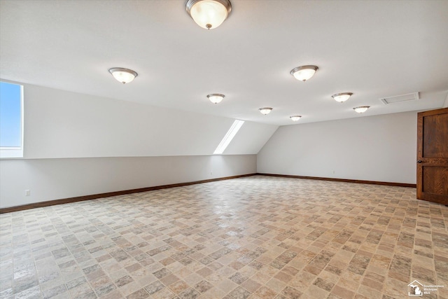 8650 Stone Rd, Maybee, MI 48159 - bonus room featuring baseboards and lofted ceiling