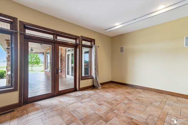 8650 Stone Rd, Maybee, MI 48159 - empty room with french doors and recessed lighting