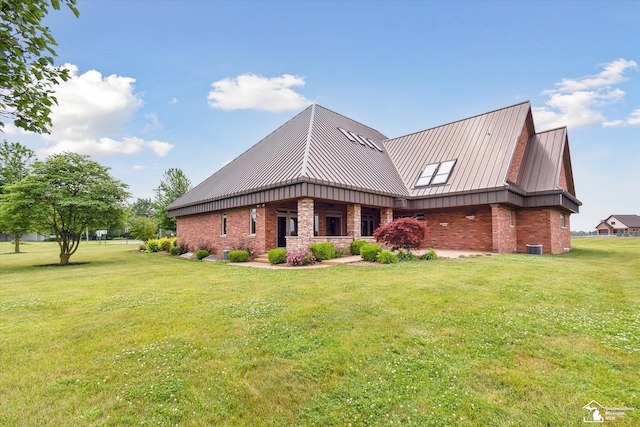 8650 Stone Rd, Maybee, MI 48159 - view of side of property featuring a standing seam roof, a yard, brick siding, and a metal roof