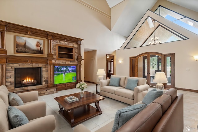 8650 Stone Rd, Maybee, MI 48159 - living area featuring light tile patterned flooring, high vaulted ceiling, a stone fireplace, plenty of natural light, and a chandelier