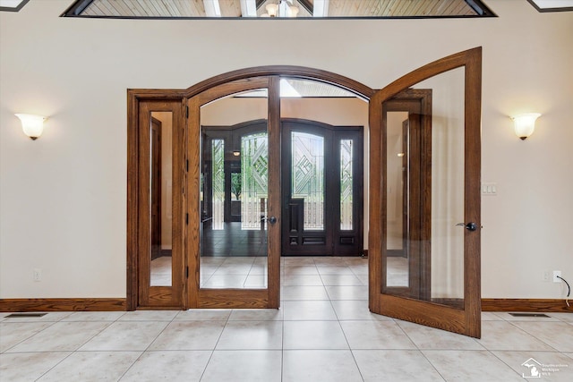 8650 Stone Rd, Maybee, MI 48159 - entrance foyer featuring arched walkways, french doors, and light tile patterned floors